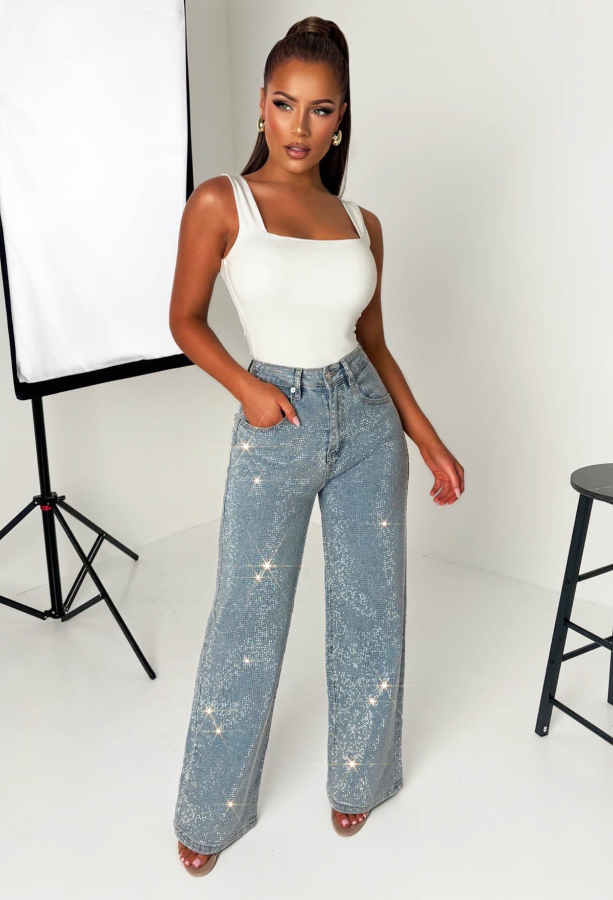 Mid wash straight leg stretch diamante jeans with all-over sparkling embellishments and classic five-pocket design.