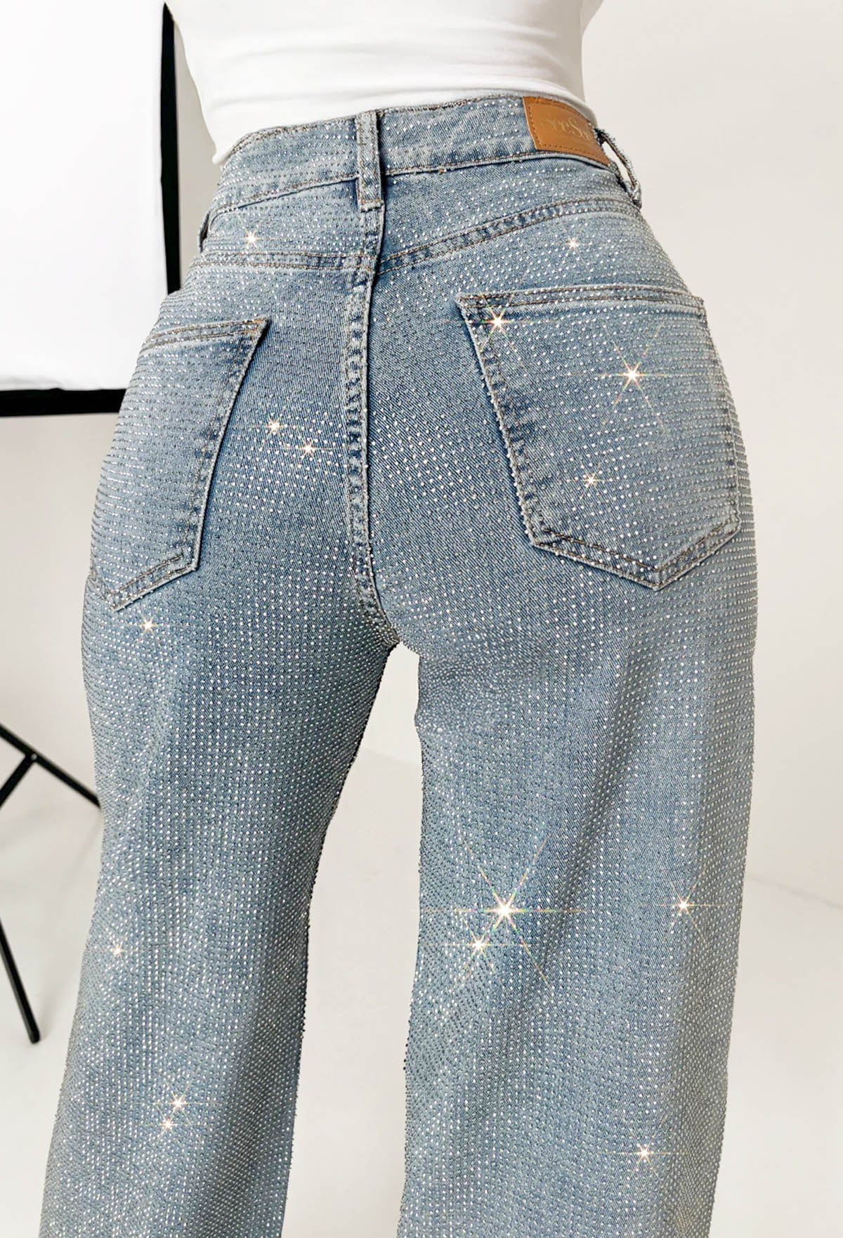 Mid wash straight leg stretch diamante jeans with all-over sparkling embellishments and classic five-pocket design.